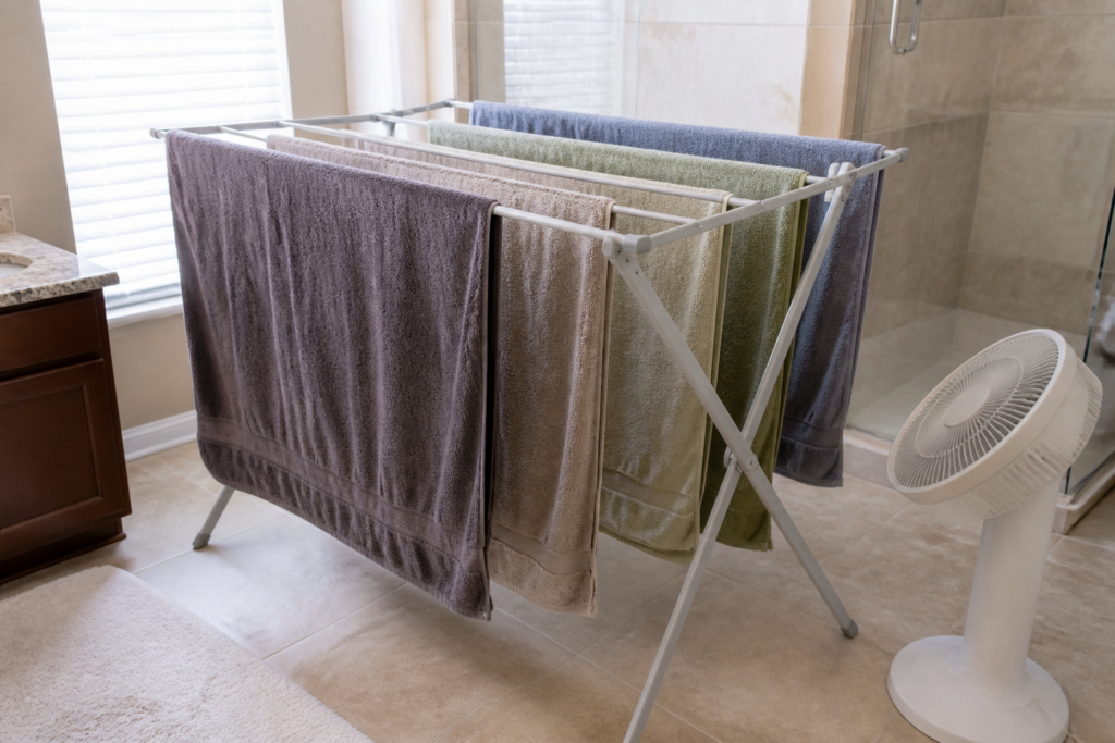 Towels spread apart on a drying rack with airflow to help them dry completely